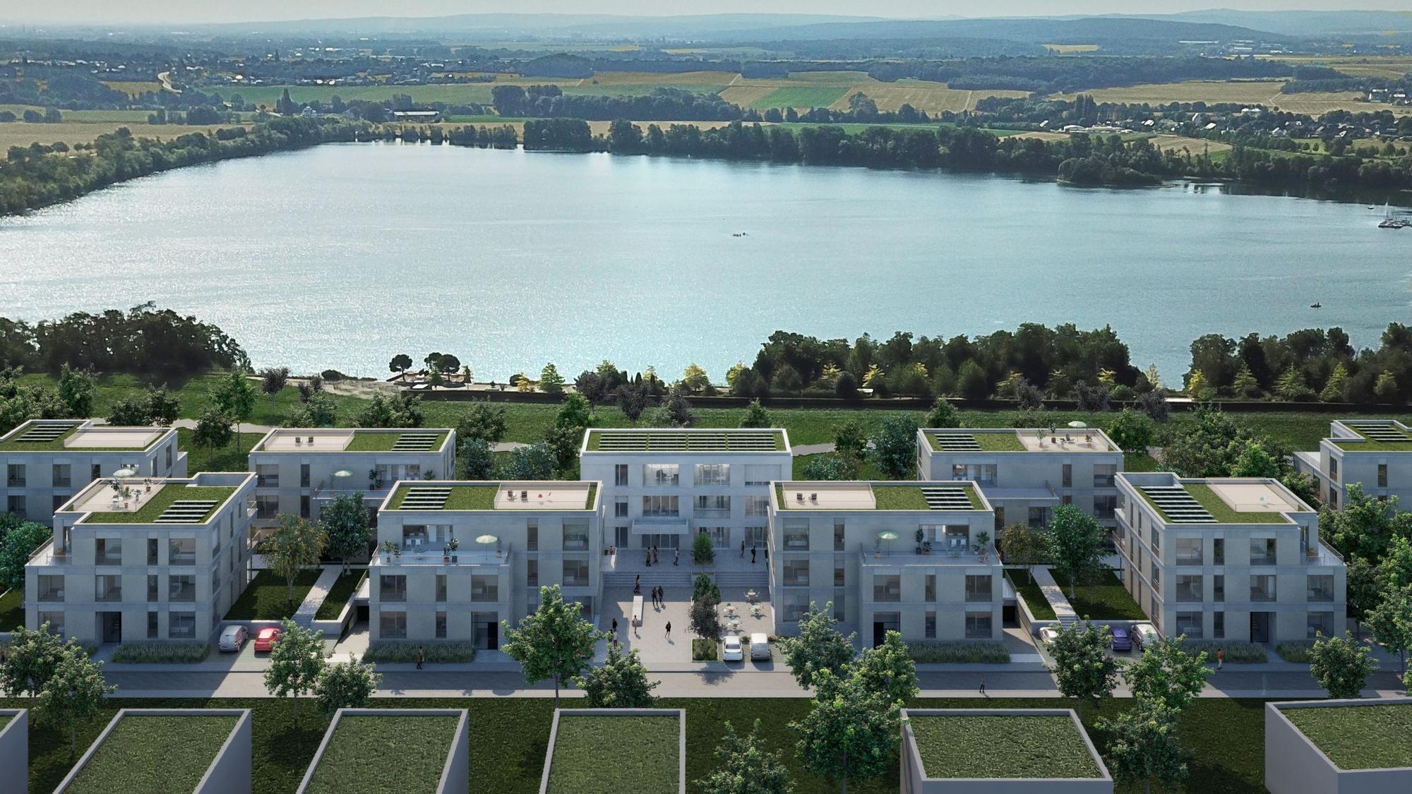 Eine Visualisierung zeigt mehrere helle Gebäude mit Gründächern vor der Kulisse des Zülpicher Wassersportsees.