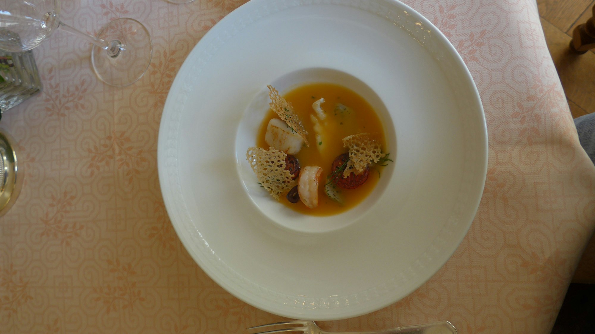 Zu sehen ist ein runder tiefer Teller mit einer Suppe.