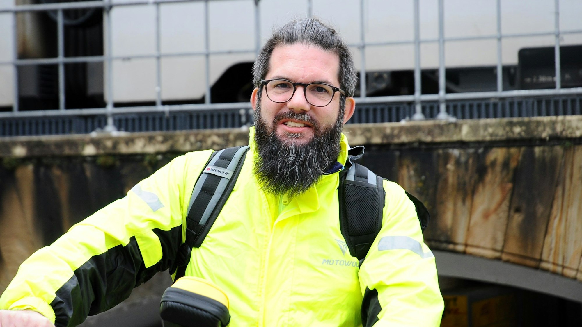 Zu sehen ist ein Mann in einer gelben Jacke.