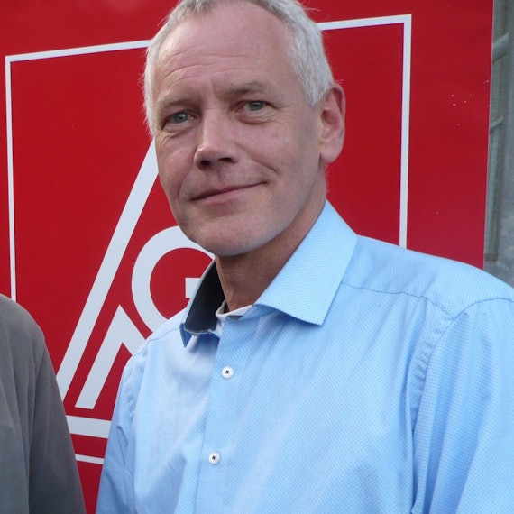 Porträt eines Mannes vor dem Symbol der IG Metall