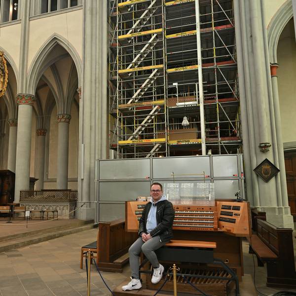 Die Orgel im Altenberger Dom ist eingerüstet. Organist Rolf Müller sitzt am elektrischen Spieltisch.