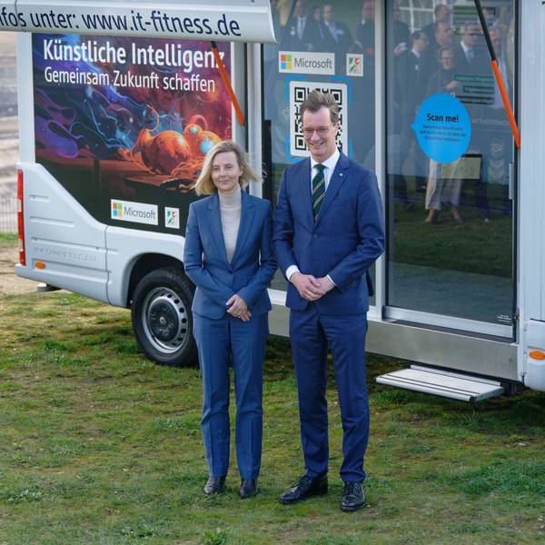 18.03.2024, Nordrhein-Westfalen, Elsdorf: Marianne Janik (l), Vorsitzende der Geschäftsführung von Microsoft Deutschland, und Hendrik Wüst, Ministerpräsident des Landes Nordrhein-Westfalen (CDU), stehen vor einer Pressekonferenz zum Thema «Von der Kohle zur KI» am Rand des Tagebau Hambach vor einem Fahrzeug, mit dem für KI-Fortbildung geworben wird. Foto: Henning Kaiser/dpa +++ dpa-Bildfunk +++
