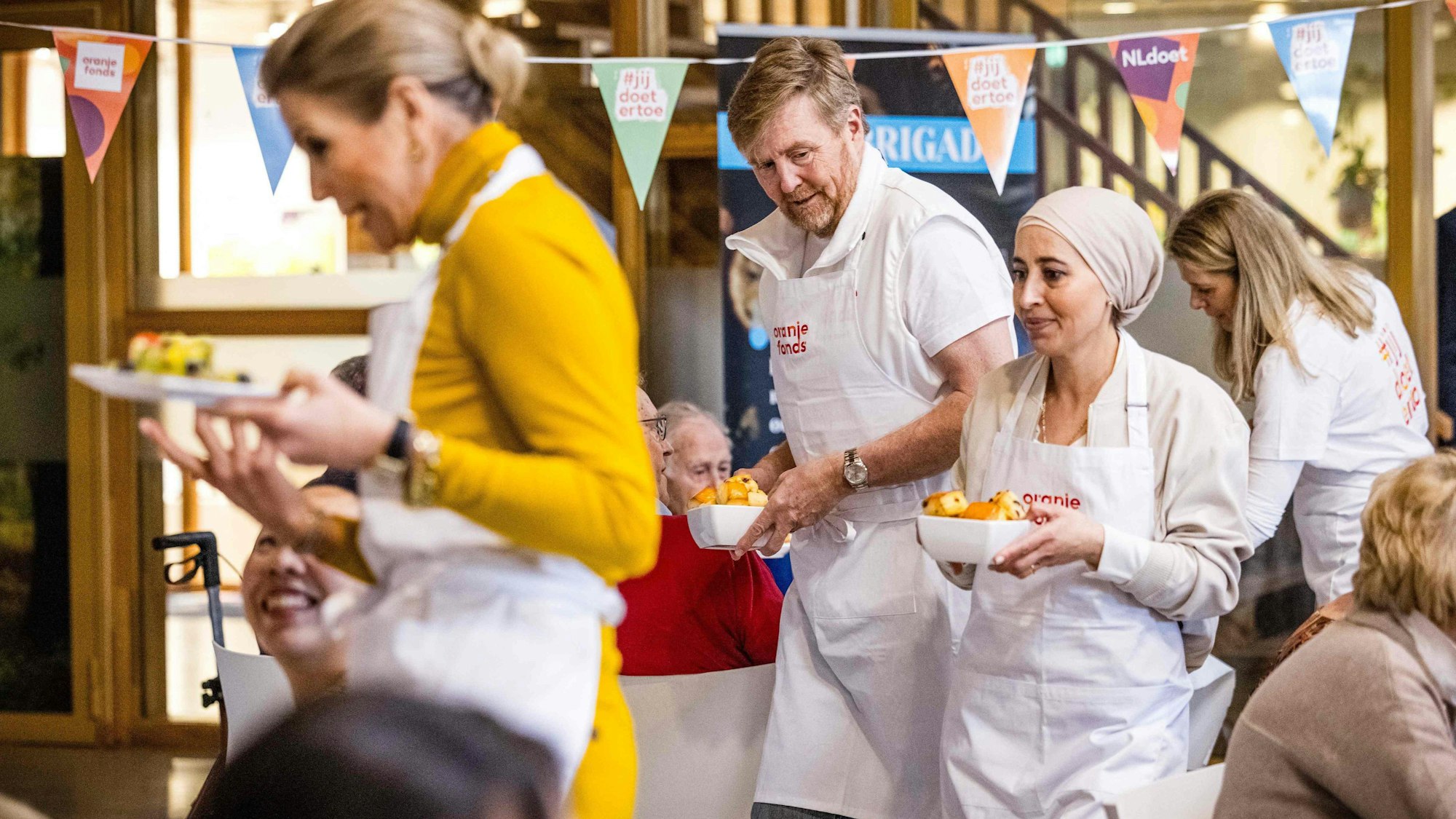 König Willem-Alexander und Königin Maxima arbeiten während der 20. Ausgabe von NLdoet, der größten Freiwilligenkampagne in den Niederlanden, ehrenamtlich in einer Küche.