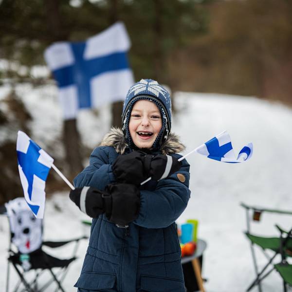 Finnish boy with Finland flags on a nice winter day. Nordic Scandinavian people.