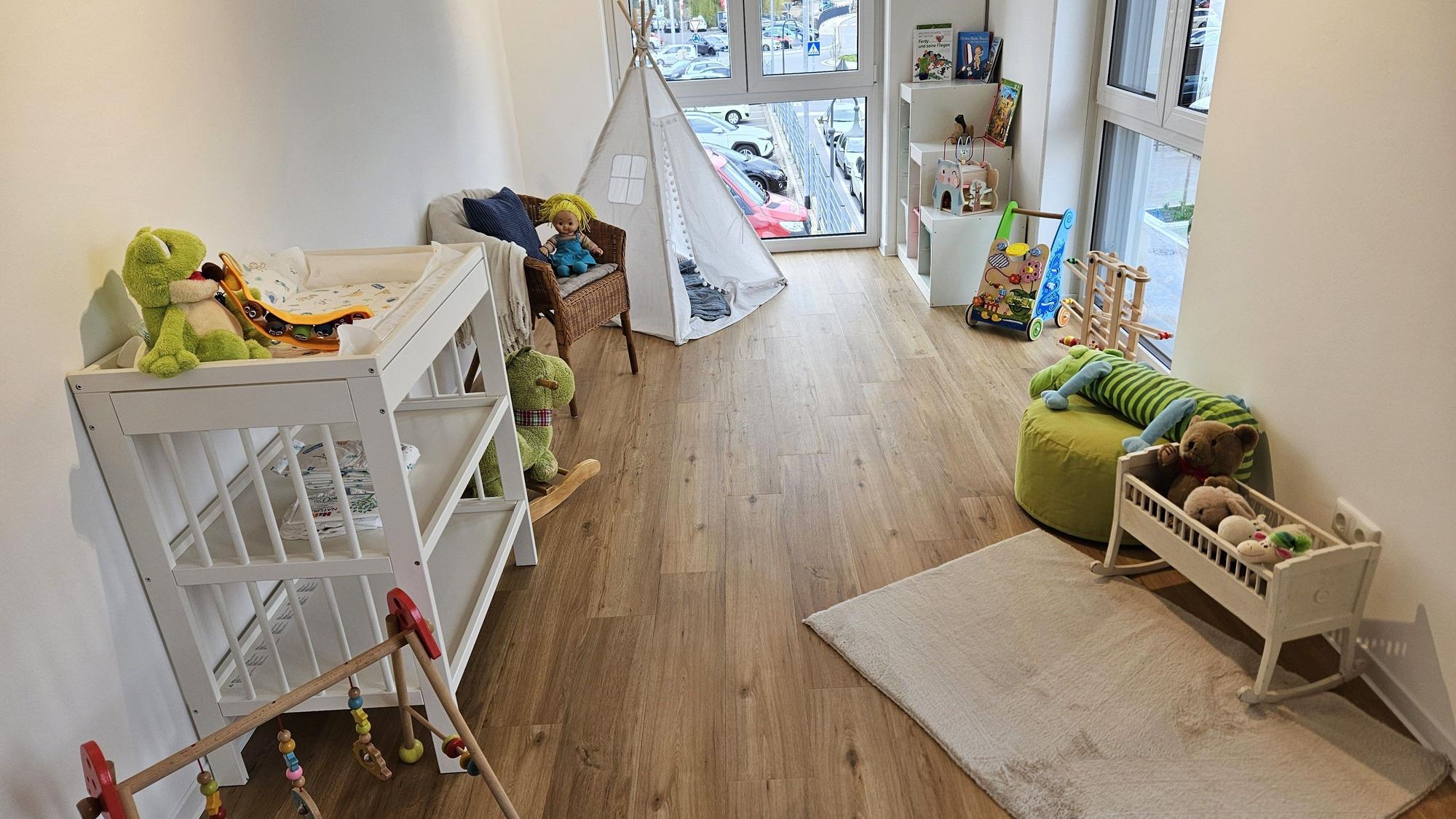Blick in ein Spielzimmer mit Puppen und einem kleinen Indianerzelt.