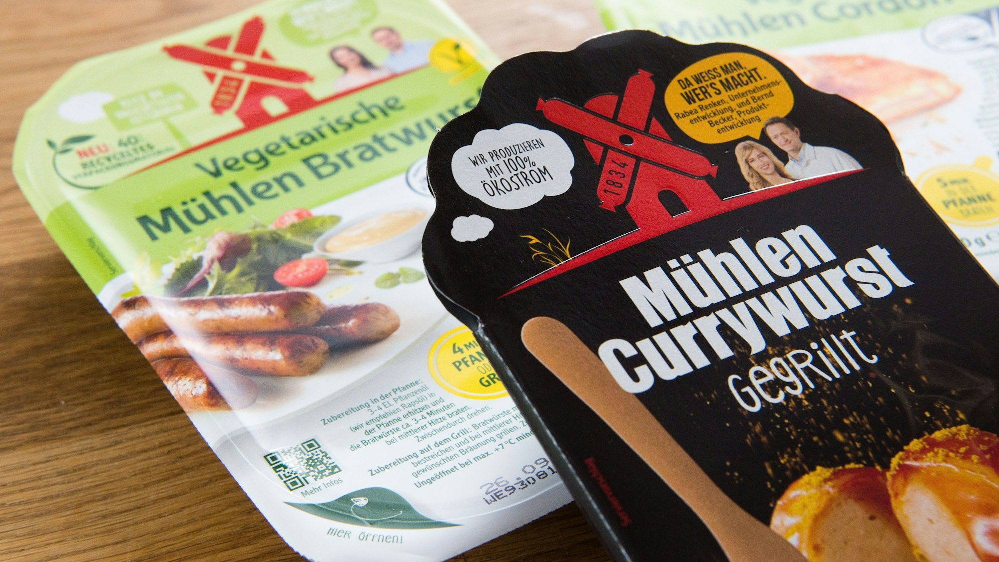 Die „Mühlen Currywurst - gegrillt“ vom Hersteller Rügenwalder Mühle liegt mit vegetarischen und veganen Produkte auf einem Tisch.
