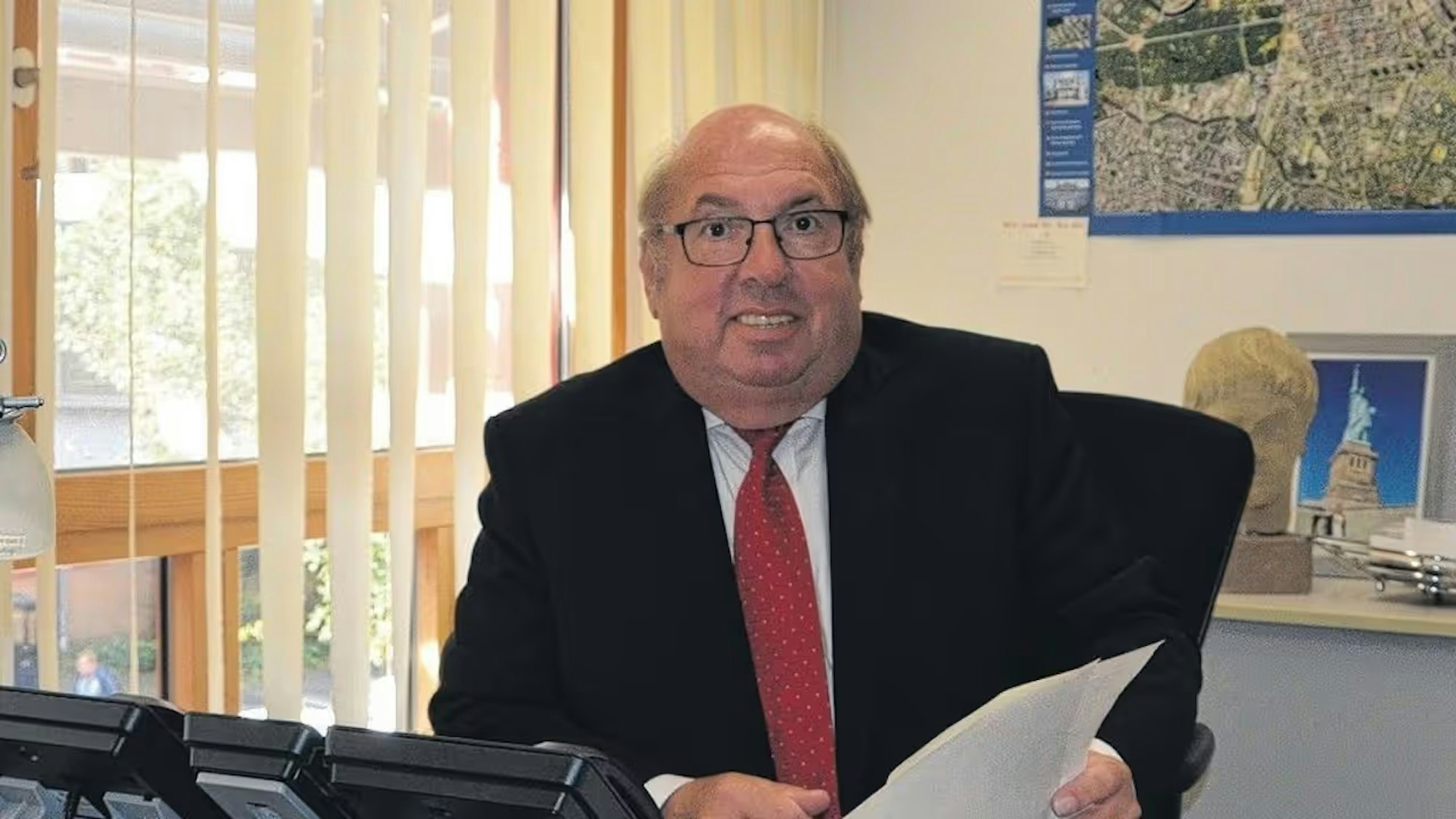 Auf dem Foto ist Willi Zylajew am Schreibtisch seines Büros im Kreishaus zu sehen.