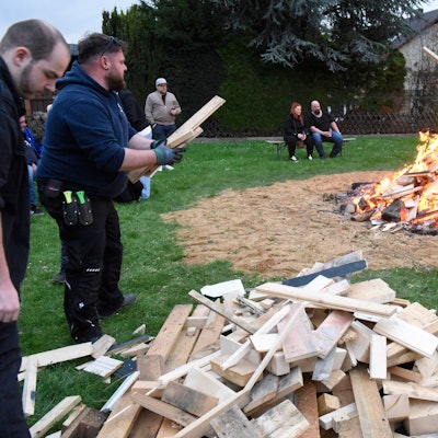 Zu sehen sind die Aktiven der Maigesellschaft beim Entfachen des Osterfeuers.