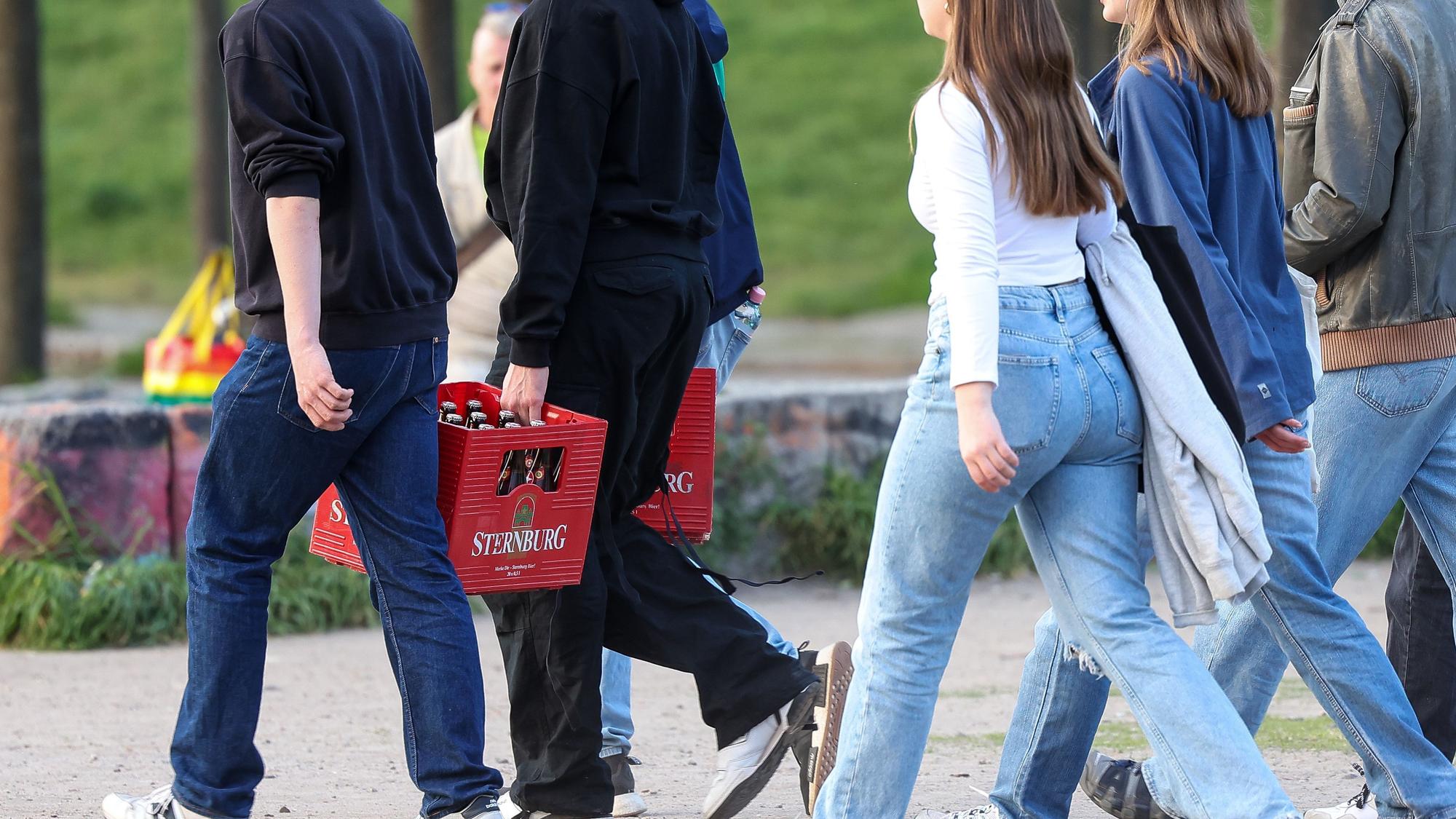 Eine Gruppe junger Erwachsener trägt Bierkästen. Der exzessive Alkoholkonsum ist unter Jugendlichen zurückgegangen.