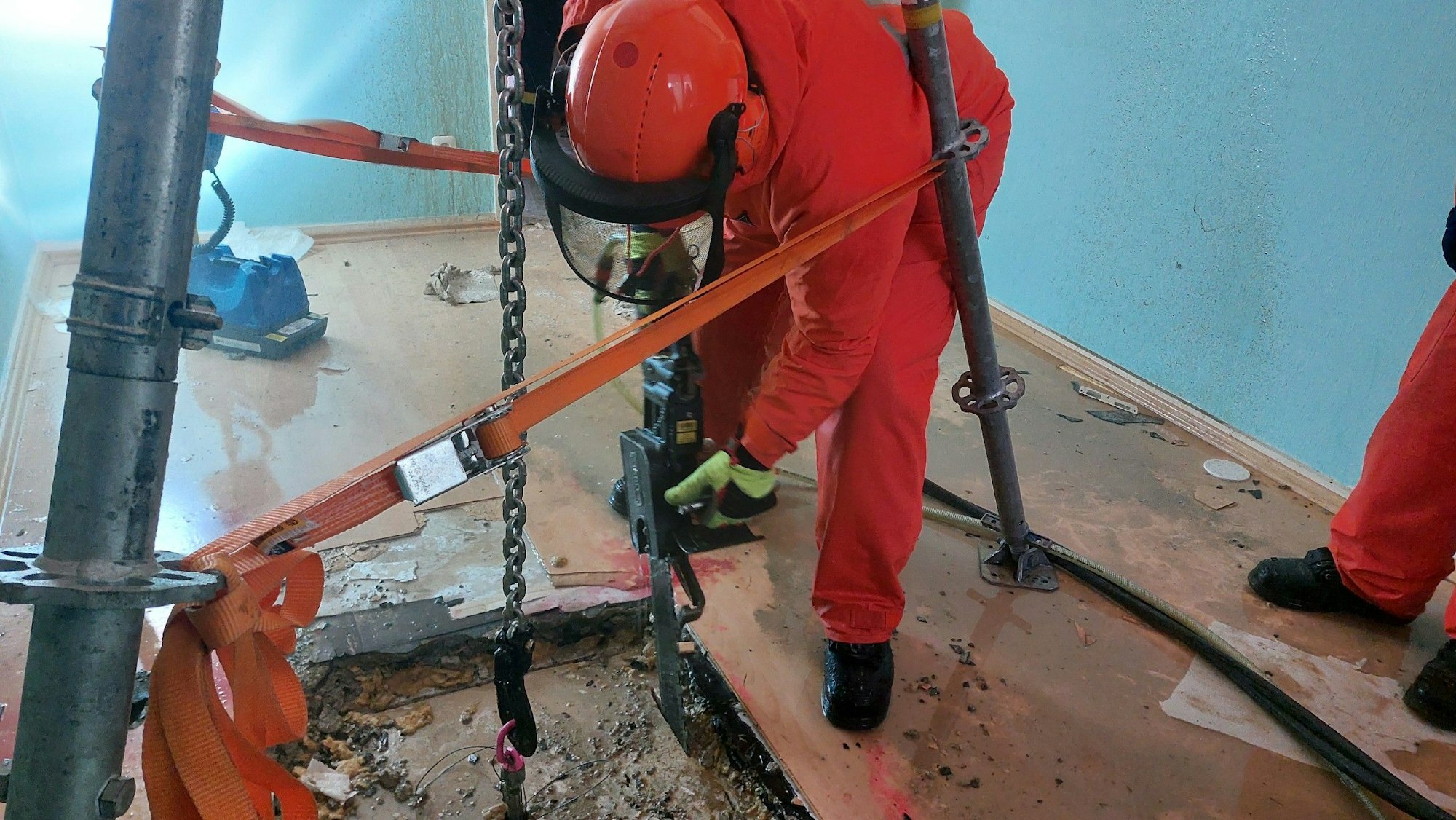 Ein THW-Helfer schneidet eine Loch in eine Betondecke.