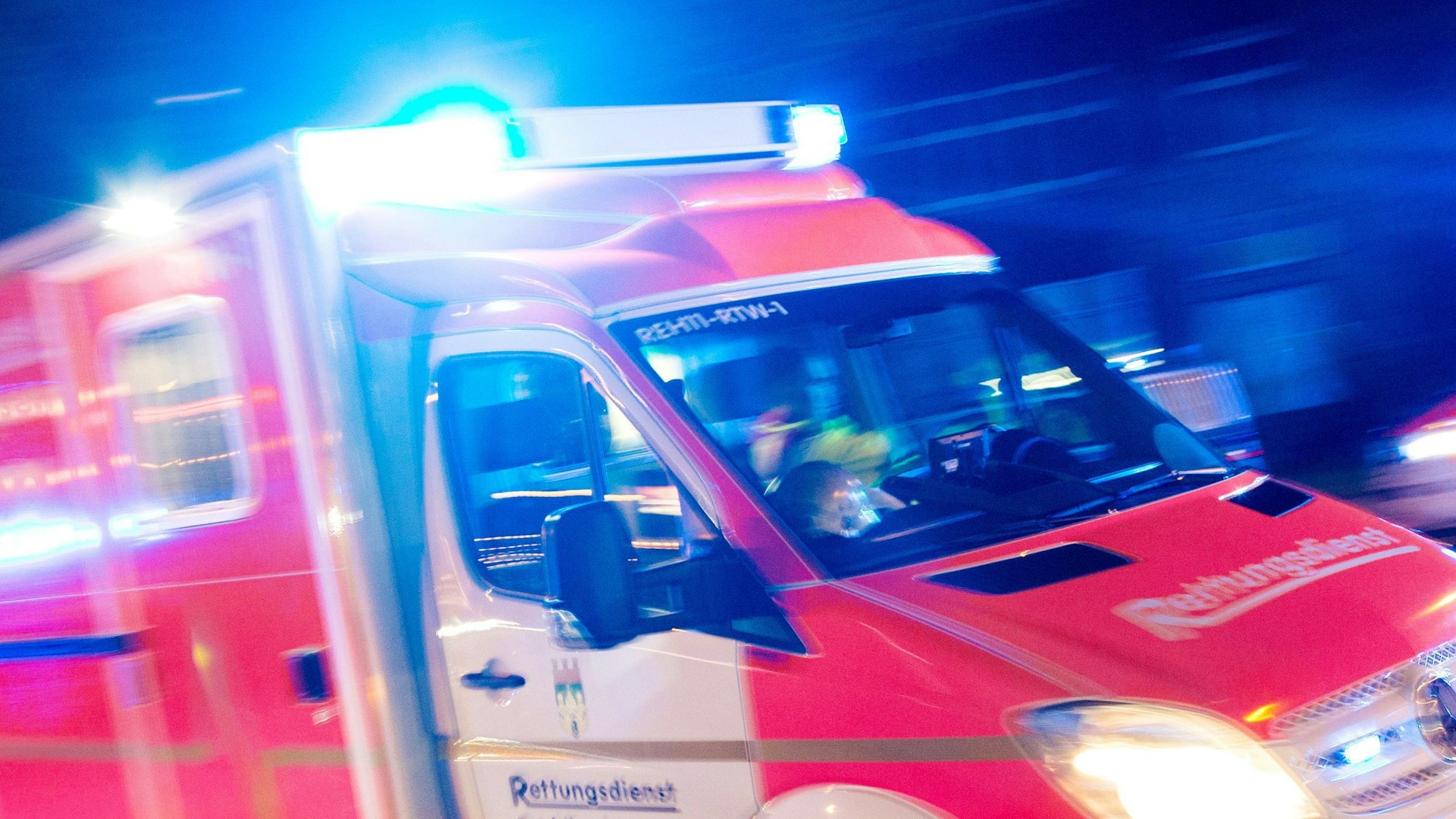 Ein Rettungswagen fährt mit Blaulicht durch eine Straße. (Symbolbild)
