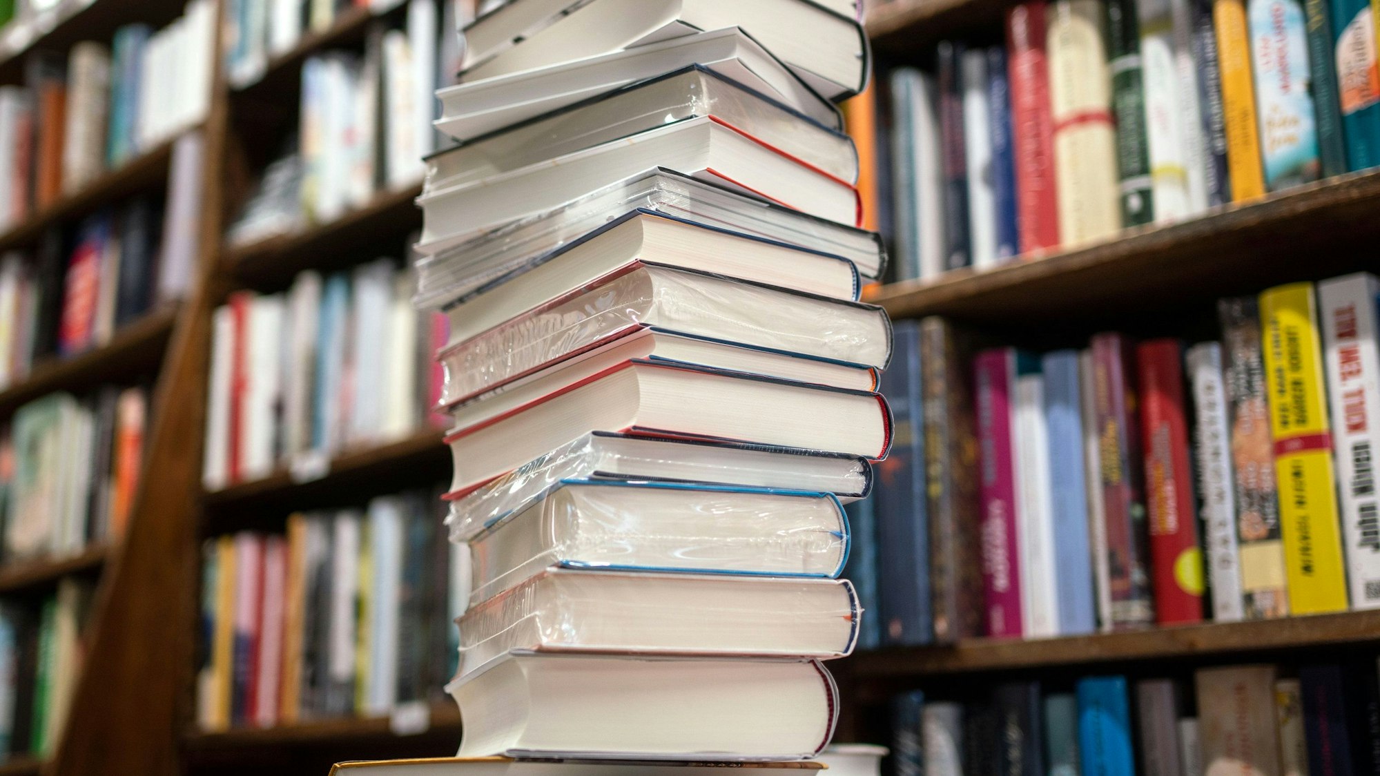 Ein Stapel neuer Bücher liegt auf einem Verkaufstisch in einer Buchhandlung im Frankfurter Stadtteil Bornheim.