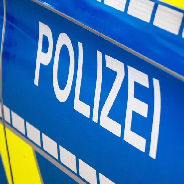 Auf einem blauen Polizeiauto steht das Wort: Polizei.