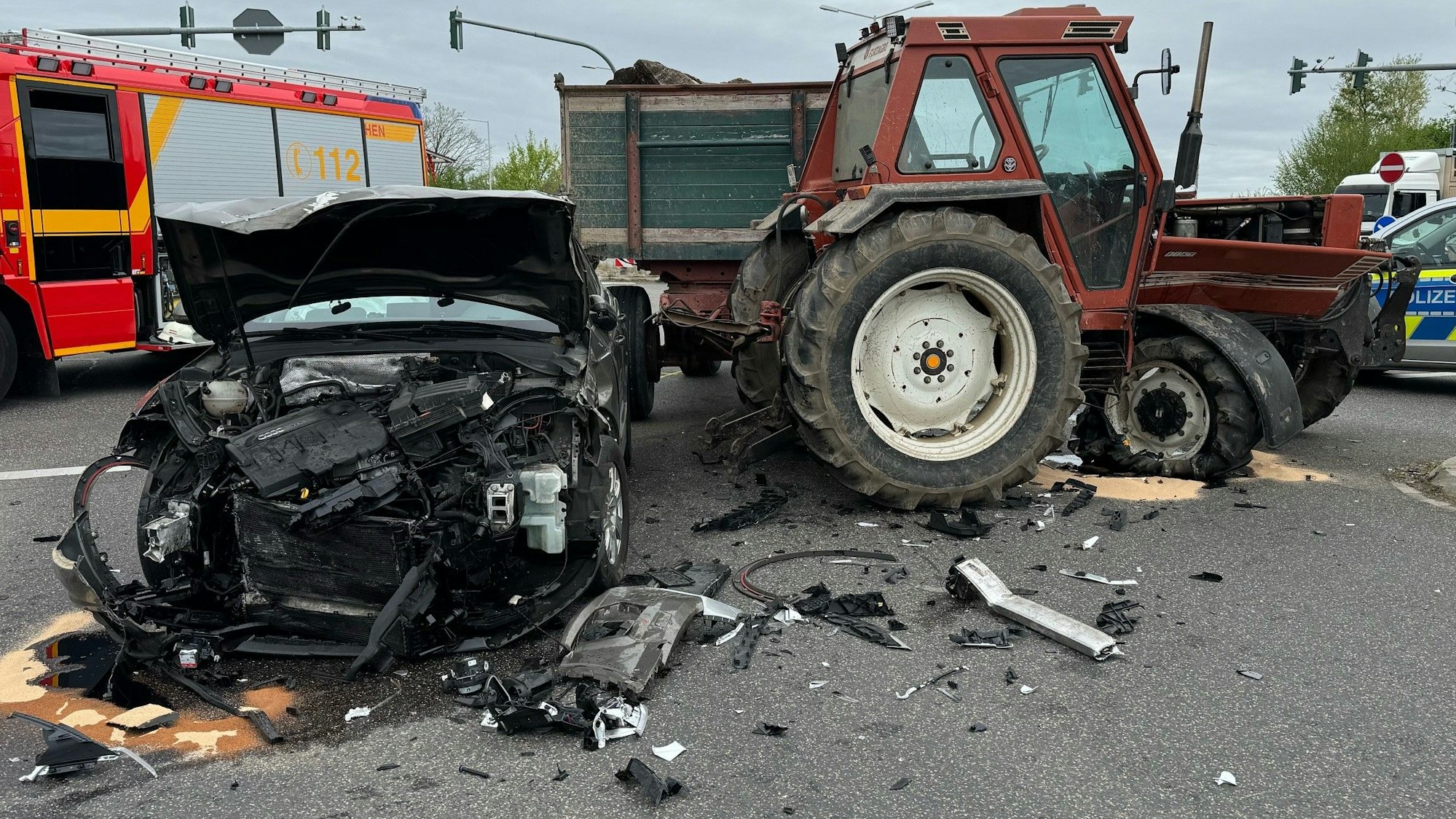 Das Bild zeigt einen beschädigten Pkw und einen beschädigten Traktor