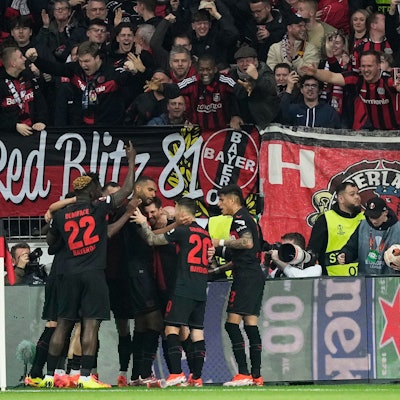 Leverkusen's Jonas Hofmann, centre, celebrates with teammates after scoring the opening goal during the Europa League quarterfinals first leg soccer match between Bayer 04 Leverkusen and West Ham United at the BayArena in Leverkusen, Germany, Thursday, April 11, 2024. (AP Photo/Martin Meissner)
