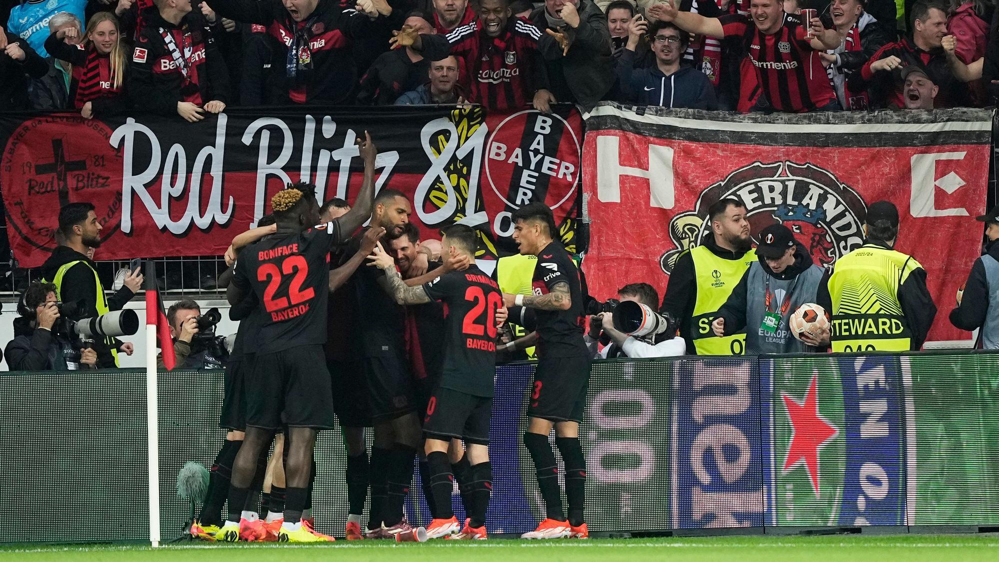 Leverkusen's Jonas Hofmann, centre, celebrates with teammates after scoring the opening goal during the Europa League quarterfinals first leg soccer match between Bayer 04 Leverkusen and West Ham United at the BayArena in Leverkusen, Germany, Thursday, April 11, 2024. (AP Photo/Martin Meissner)