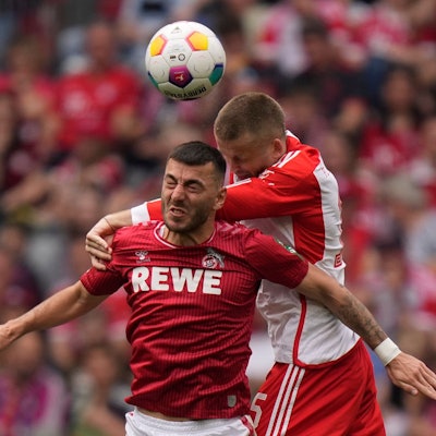 Cologne's Sargis Adamyan, left, jumps for a header with Bayern's Eric Dier during the German Bundesliga soccer match between Bayern Munich and Cologne at the Allianz Arena in Munich, Germany, Saturday, April 13, 2024. (AP Photo/Matthias Schrader)