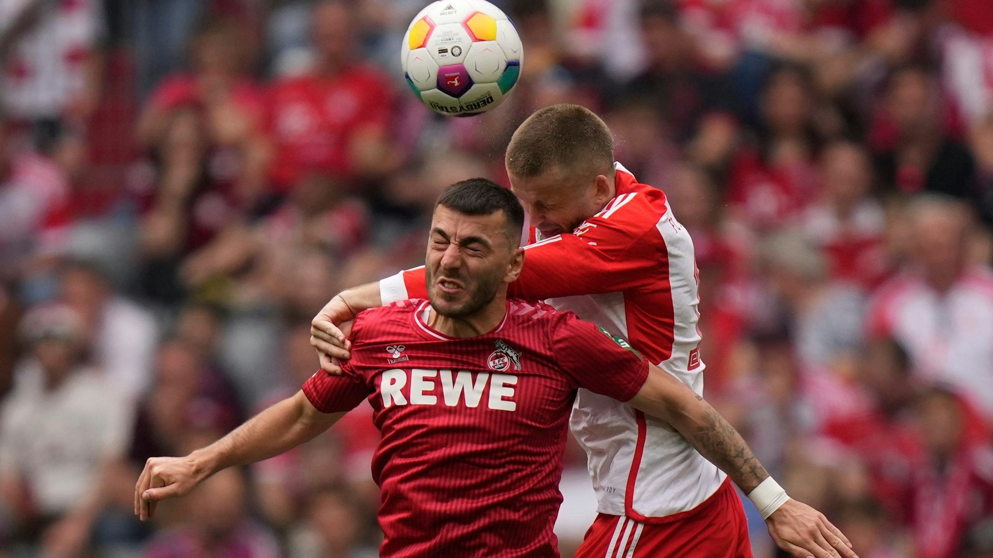 Cologne's Sargis Adamyan, left, jumps for a header with Bayern's Eric Dier during the German Bundesliga soccer match between Bayern Munich and Cologne at the Allianz Arena in Munich, Germany, Saturday, April 13, 2024. (AP Photo/Matthias Schrader)