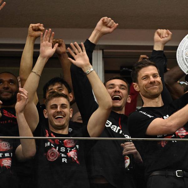 Bayer Leverkusen's Spanish head coach Xabi Alonso celebrates with a mock-up of the Bundesliga trophy with his players after the German first division Bundesliga football match Bayer 04 Leverkusen v Werder Bremen in Leverkusen, western Germany, on April 14, 2024. Bayer Leverkusen were crowned 2023-24 Bundesliga champions for the first time on April 14, 2024. (Photo by INA FASSBENDER / AFP) / DFL REGULATIONS PROHIBIT ANY USE OF PHOTOGRAPHS AS IMAGE SEQUENCES AND/OR QUASI-VIDEO