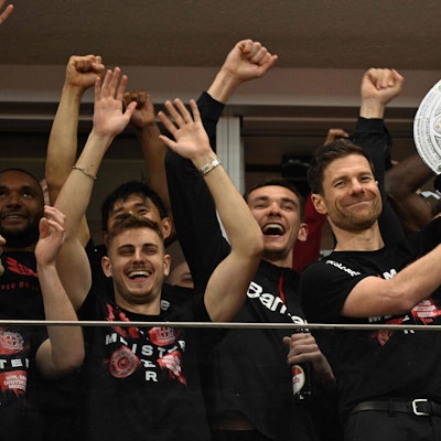 Bayer Leverkusen's Spanish head coach Xabi Alonso celebrates with a mock-up of the Bundesliga trophy with his players after the German first division Bundesliga football match Bayer 04 Leverkusen v Werder Bremen in Leverkusen, western Germany, on April 14, 2024. Bayer Leverkusen were crowned 2023-24 Bundesliga champions for the first time on April 14, 2024. (Photo by INA FASSBENDER / AFP) / DFL REGULATIONS PROHIBIT ANY USE OF PHOTOGRAPHS AS IMAGE SEQUENCES AND/OR QUASI-VIDEO