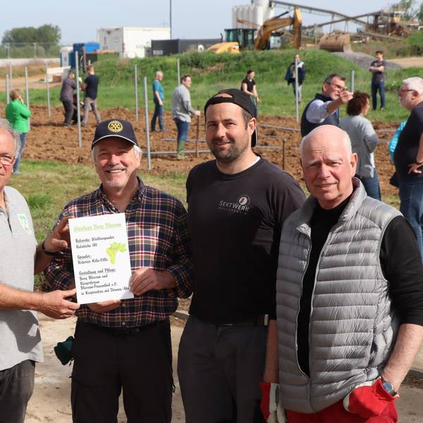 Das Bild zeigt mehrere Personen vor dem neuen Weinberg