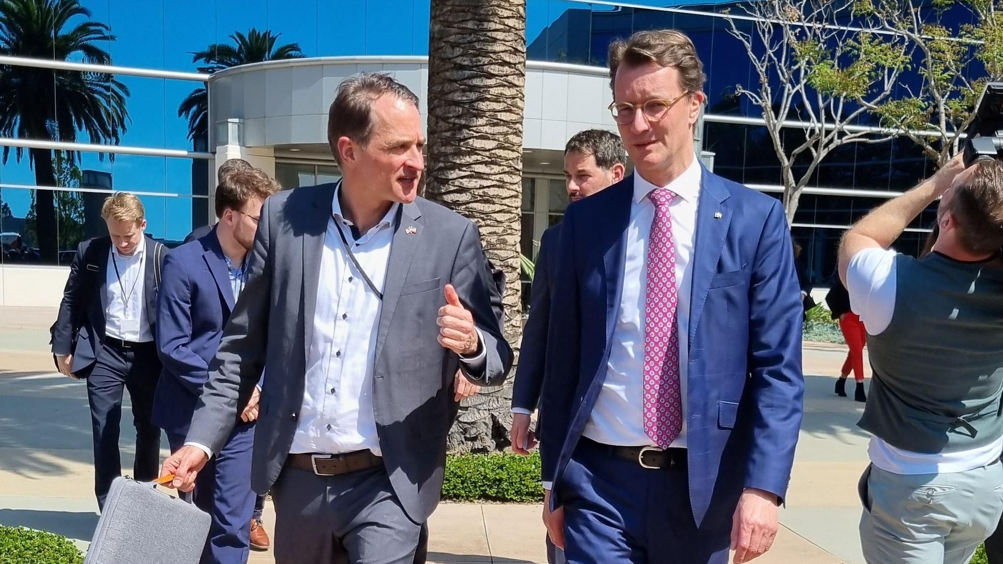 Hendrik Wüst ist mit einer Entourage zu sehen auf dem Weg zu einem Veranstaltungsort.