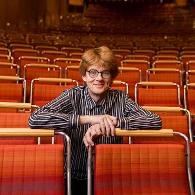 Enno Poppe sitzt in den Stuhlreihen der Kölner Philharmonie.