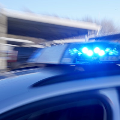 Ein Polizeiauto fährt mit Blaulicht.