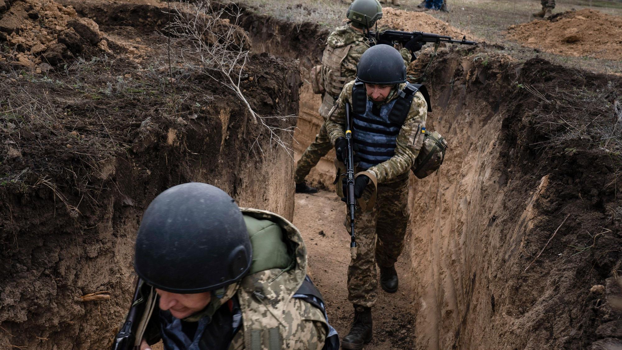 Ukrainische Soldaten bei einem militärischen Training in einem Schützengraben zu Beginn des Ukraine-Krieges 2022.