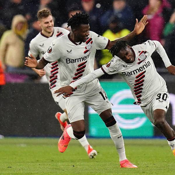 Leverkusen's Jeremie Frimpong, right, celebrates after scoring his side's opening goal during the Europa League quarterfinal second leg soccer match between West Ham and Bayer 04 Leverkusen in London, Thursday, April 18, 2024. John Walton/PA via AP)