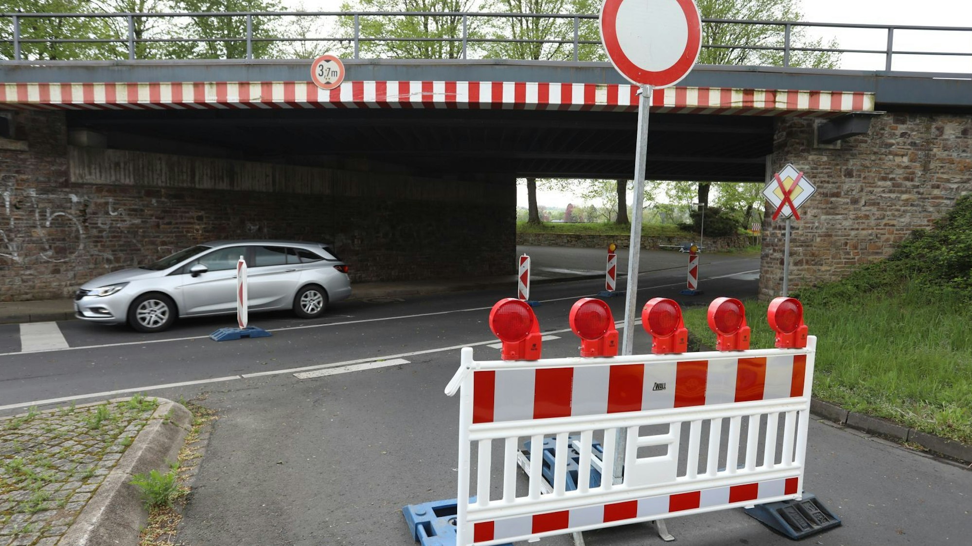 Eine rot-weiße Absperrung verhindert das Befahren einer Straße.