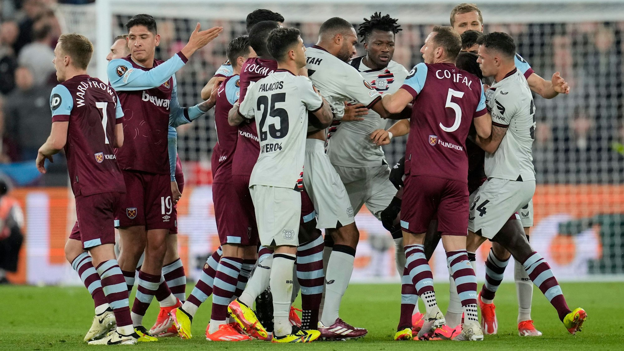Players scuffle during the Europa League quarterfinal second leg soccer match between West Ham and Bayer 04 Leverkusen in London, Thursday, April 18, 2024.(AP Photo/Kin Cheung)