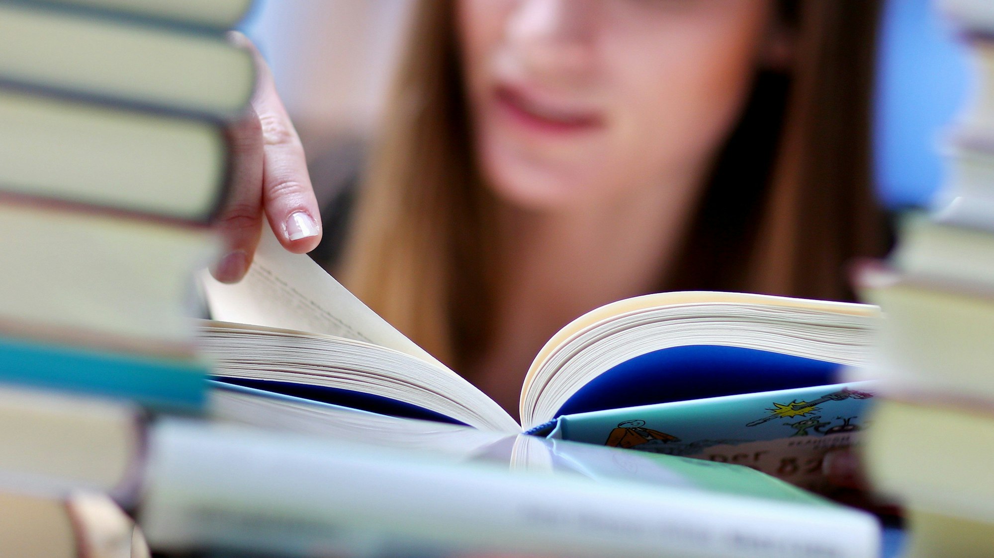 Eine Frau liest auf der Buchmesse in Leipzig (Archivbild)