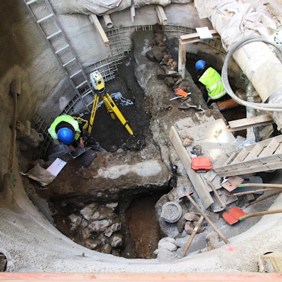 Archäologen arbeiten in einer Baugrupe.