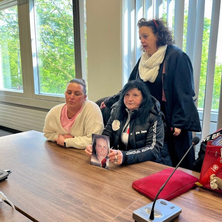 Schwester (links) und Mutter hatten zum Prozessauftakt ein Foto des Mordopfers mitgebracht.