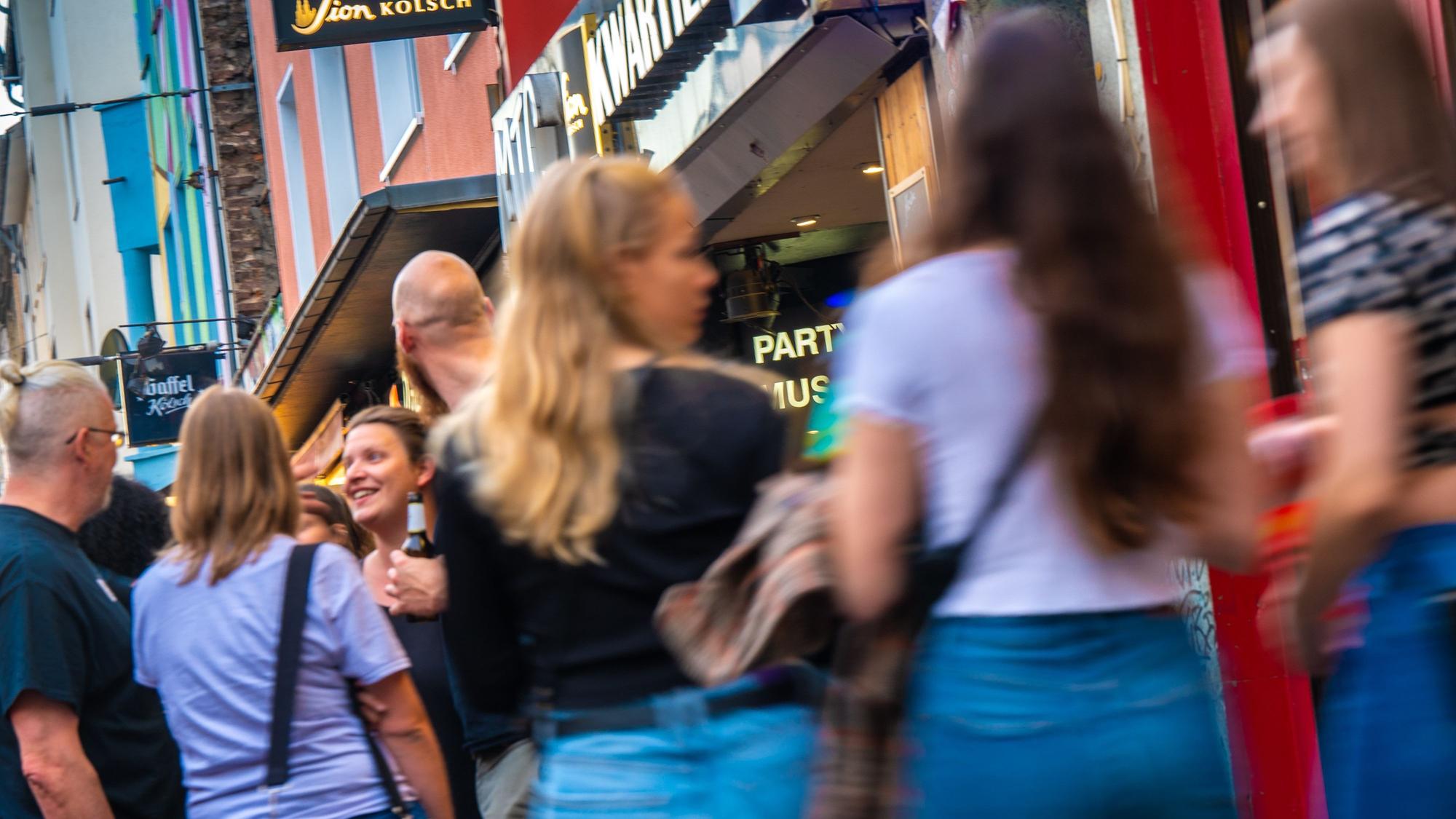 Junge Leute flanieren in Feierlaune durchs Kwartier Lateng.