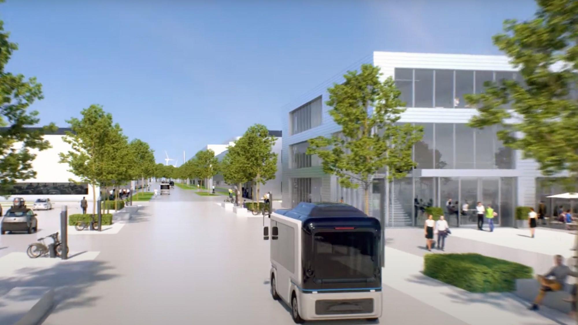 Das Bild zeigt einen Blick auf den Campus, Im Vordergrund fährt ein Bus.