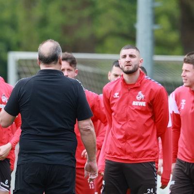 Der aufgebrachte Fan richtete nach Aufforderung durch Co-Trainer Kevin McKenna (l.) das Wort an die FC-Profis.