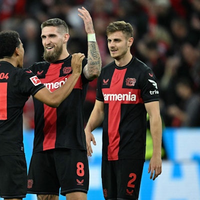 Bayer Leverkusen's French forward #21 Amine Adli, Bayer Leverkusen's German midfielder #08 Robert Andrich and Bayer Leverkusen's Croatian defender #02 Josip Stanisic celebrate after the German first division Bundesliga football match Bayer 04 Leverkusen v VfL Stuttgart in Leverkusen, western Germany, on April 27, 2024. (Photo by INA FASSBENDER / AFP) / DFL REGULATIONS PROHIBIT ANY USE OF PHOTOGRAPHS AS IMAGE SEQUENCES AND/OR QUASI-VIDEO