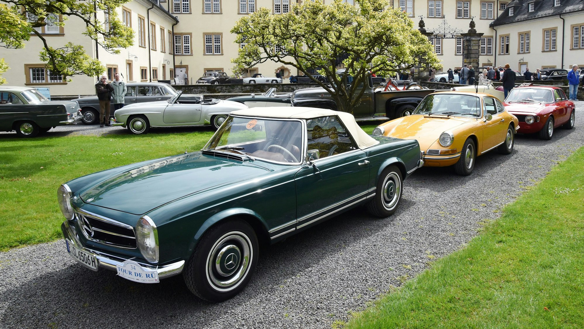 Oldtimer stehen Stoßstange an Stoßstange im Innenhof von Schloss Ehreshoven bei Engelskirchen.