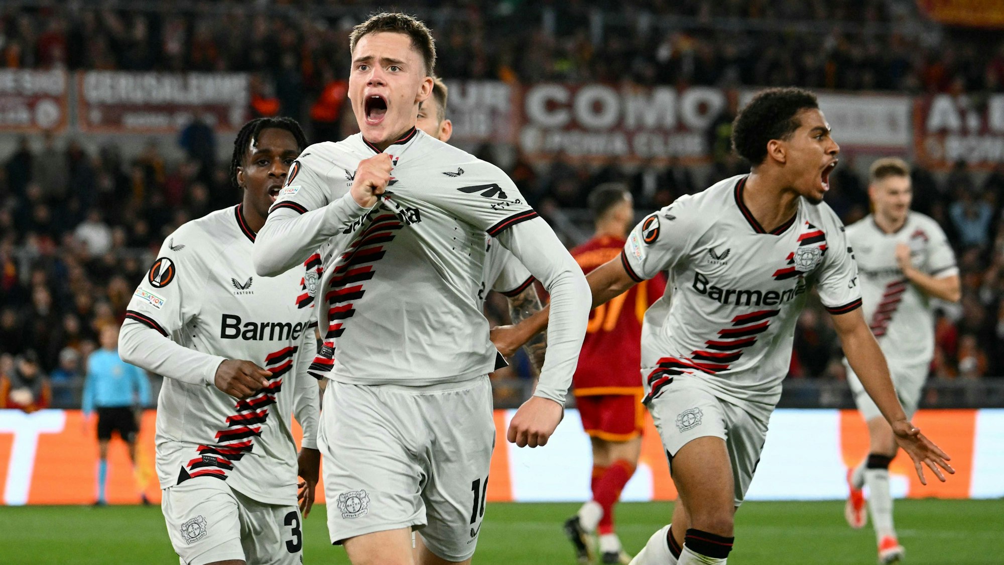 Bayer Leverkusen's German midfielder #10 Florian Wirtz celebrates with teammates after scoring his team first goal during the UEFA Europa League semi final first leg football match between AS Roma and Bayern Leverkusen at the Olympic stadium on May 2, 2024 in Rome. (Photo by Alberto PIZZOLI / AFP)