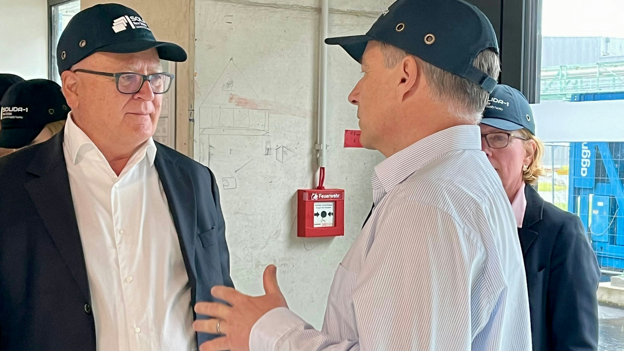 EU-Kommissar Nicolas Schmit lässt sich von Projektleiter Jürgen Wiedemann die neue Tablettenproduktion zeigen.