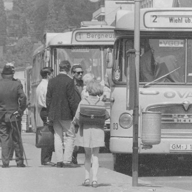 Historische Aufnahme vom Treiben an einer Bushaltestelle