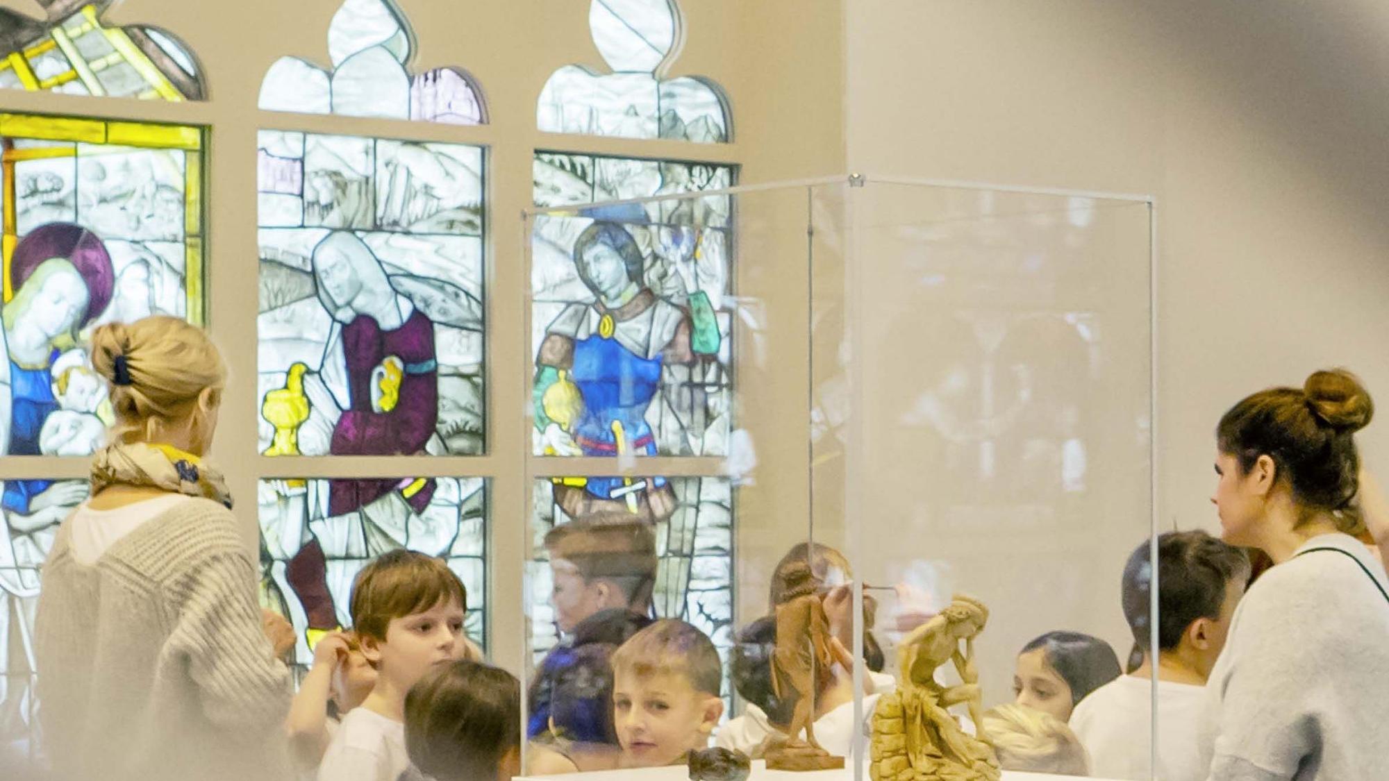 Das Foto zeigt Kinder und Erwachsene bei einem Museumsbesuch.