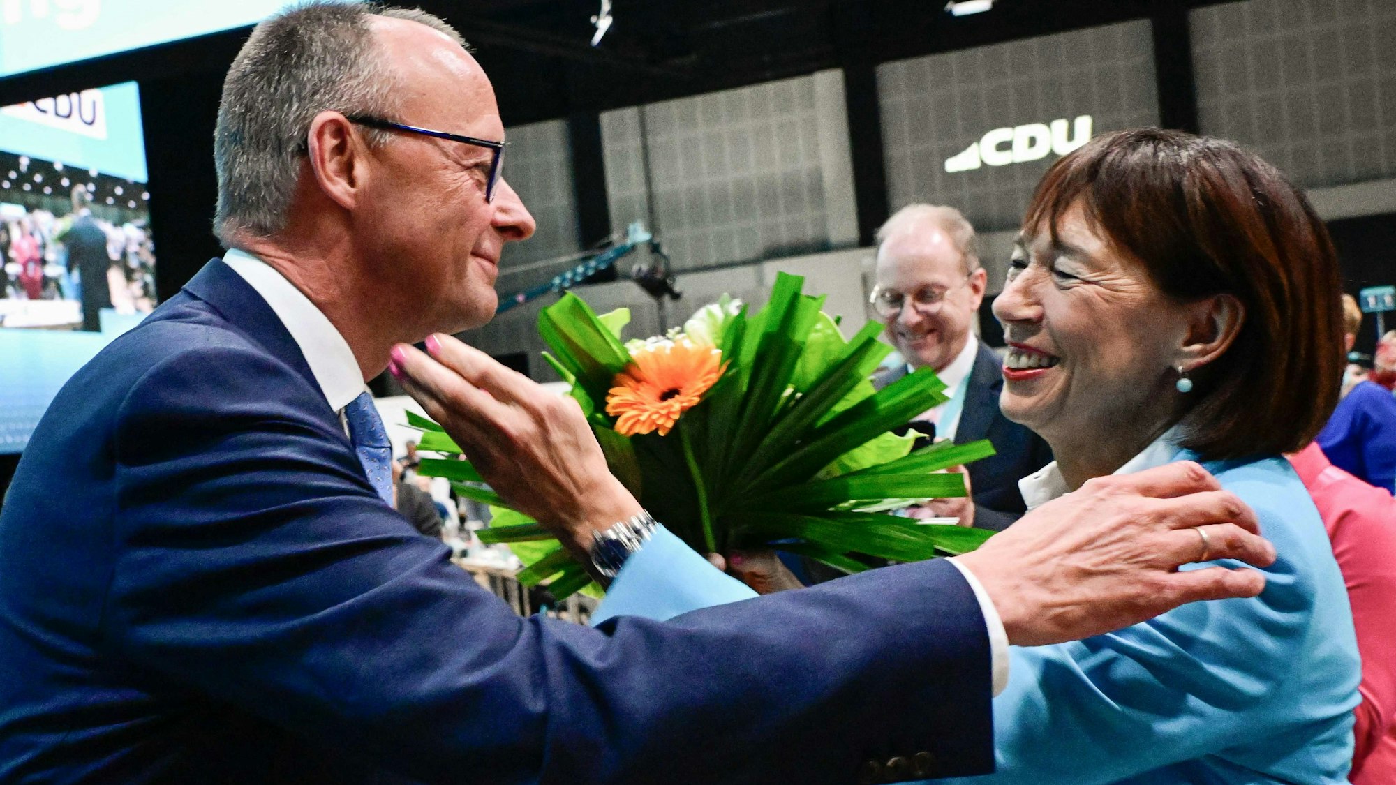 The leader of Germany's conservative Christian Democratic Union (CDU) party Friedrich Merz hugs his wife Charlotte Merz after being reelected as the party leader on the first day of the CDU party congress at the Estrel Berlin Hotel in Berlin, on May 6, 2024. Merz was reelected as party leader by 90%. The 36th Conservative Christian Democratic Union (CDU) party Congress is held in Berlin from May 6 to May 8, 2024. (Photo by Tobias SCHWARZ / AFP)