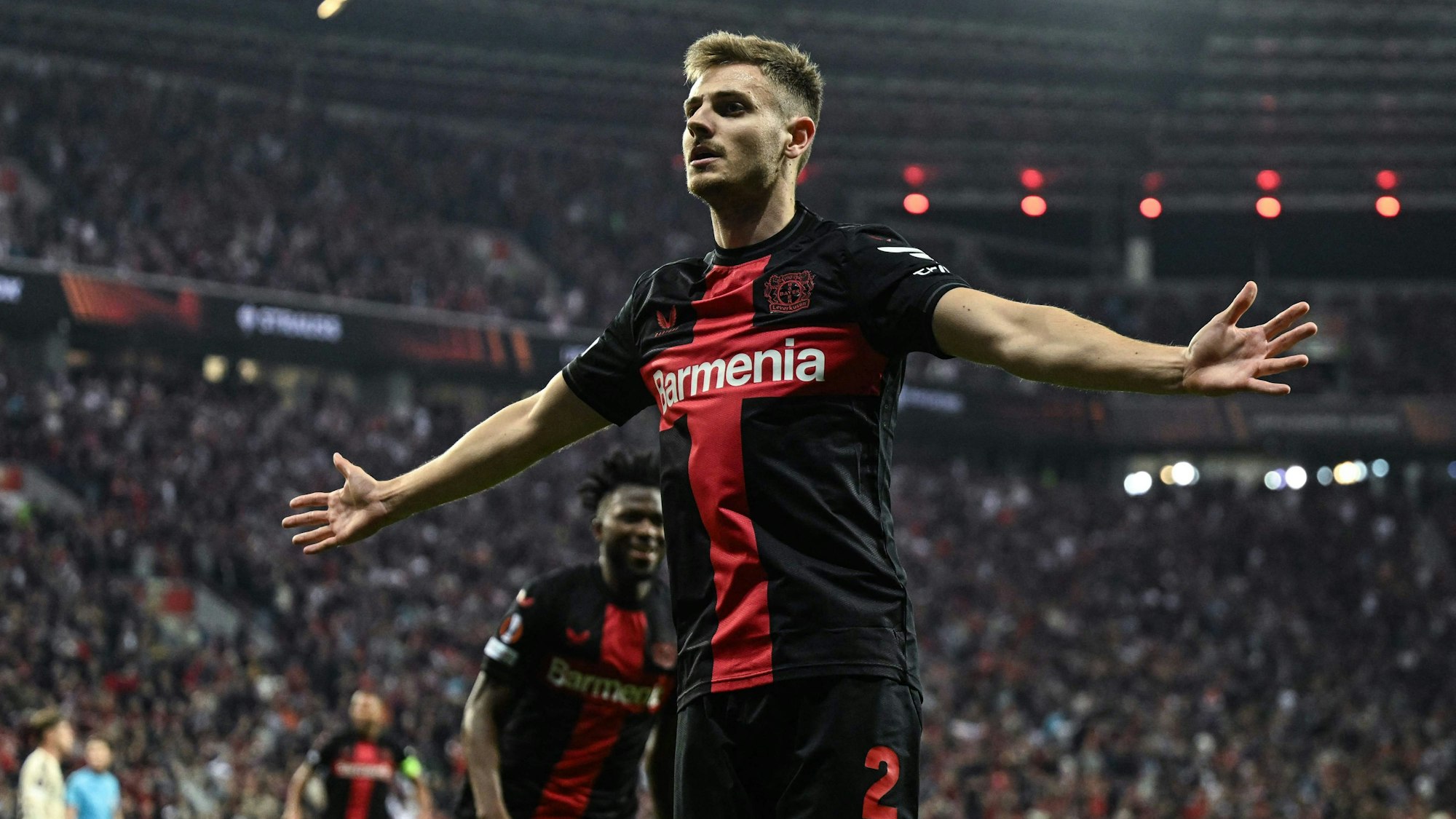 Bayer Leverkusen's Croatian defender #02 Josip Stanisic celebrates scoring the 2-2 during the UEFA Europa League semi final second leg football match between Bayer Leverkusen and ASC Roma in Leverkusen, on May 9, 2024. (Photo by INA FASSBENDER / AFP)