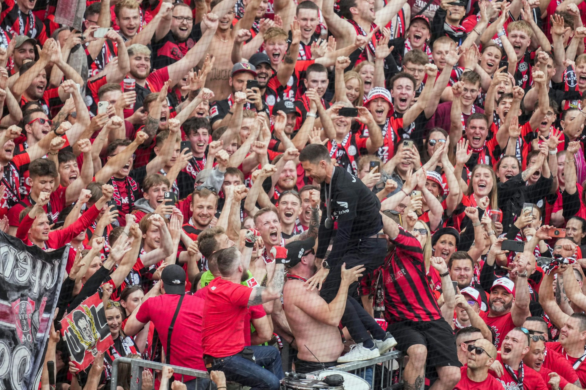 Leverkusen's head coach Xabi Alonso celebrates with fans as his team won the German Bundesliga, after the German Bundesliga soccer match between Bayer Leverkusen and FC Augsburg at the BayArena in Leverkusen, Germany, Saturday, May 18, 2024. Bayer Leverkusen have won the Bundesliga title for the first time. It is the first team in Bundesliga history, that won the championship unbeaten for the whole season. (AP Photo/Michael Probst)
