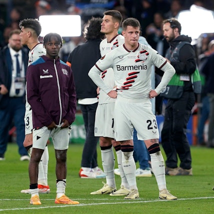 Bayer Leverkusen's Jeremie Frimpong, Adam Hlozek and Amine Adli, from left, react after the team's Europa League final against Atalanta on Wednesday May 22, 2024, in Dublin, Ireland. (Brian Lawless/PA via AP)