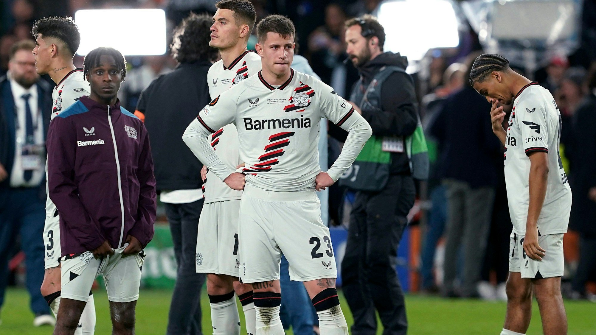 Bayer Leverkusen's Jeremie Frimpong, Adam Hlozek and Amine Adli, from left, react after the team's Europa League final against Atalanta on Wednesday May 22, 2024, in Dublin, Ireland. (Brian Lawless/PA via AP)