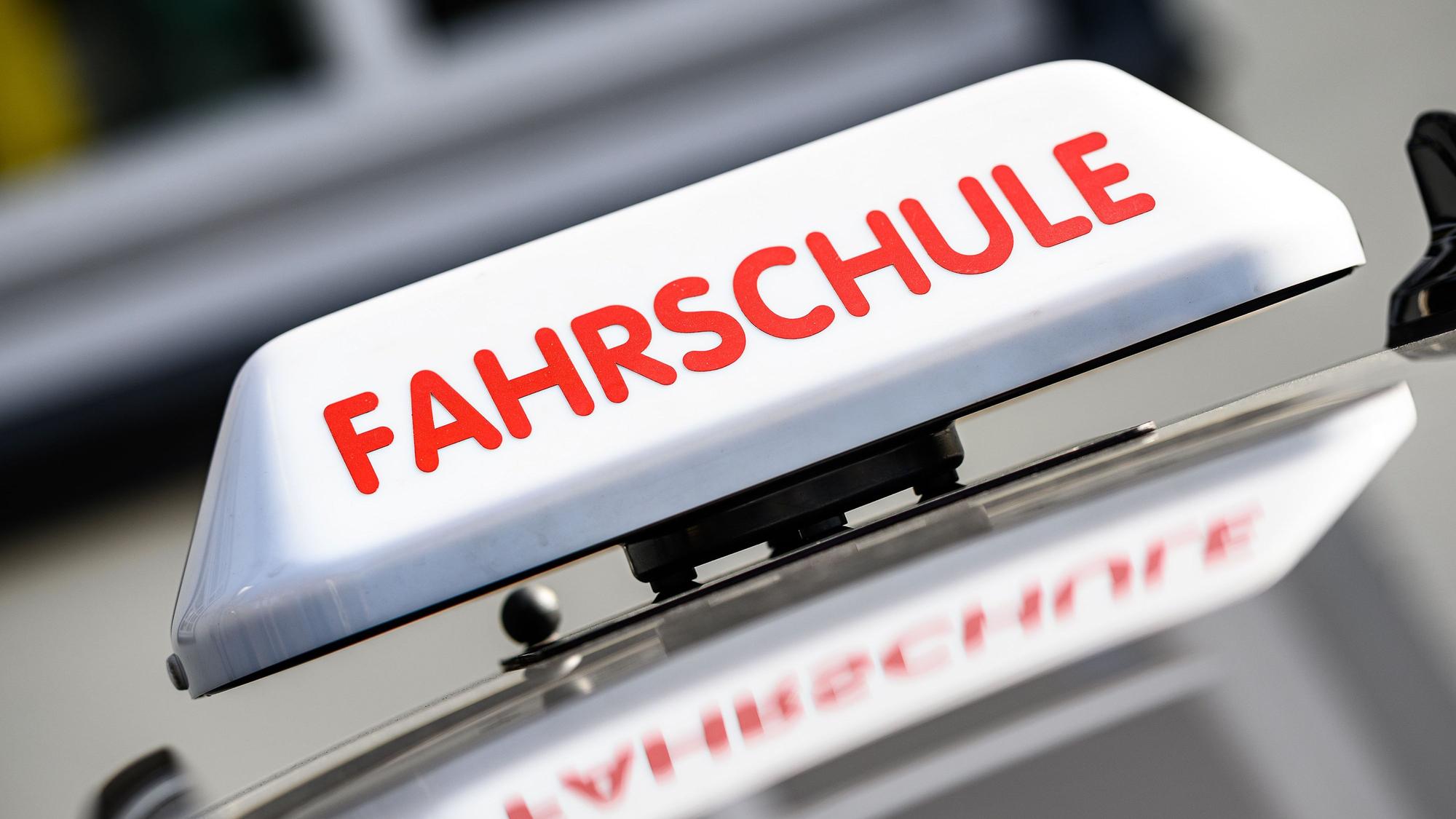 Ein Dachzeichen mit der Aufschrift "Fahrschule" ist an einem Fahrschulauto angebracht.
